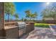 Built-in stainless steel grill and stone counter in outdoor kitchen area at 2735 E Flower Ct, Gilbert, AZ 85298