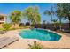 Sparkling backyard pool featuring a stone patio and lush landscaping at 2735 E Flower Ct, Gilbert, AZ 85298