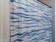 Close up of a blue and white shower curtain hung on a metal rod at 2735 E Flower Ct, Gilbert, AZ 85298