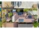 Aerial view showcases a home's tile roof, solar panels, pool, and landscaped backyard at 30248 W Earll Dr, Buckeye, AZ 85396