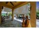 The covered patio transitions to an outdoor entertainment area with a BBQ, perfect for entertaining or relaxing at 30248 W Earll Dr, Buckeye, AZ 85396