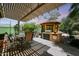 An inviting backyard features a covered patio, BBQ, and lush greenery, offering a relaxing outdoor space at 30248 W Earll Dr, Buckeye, AZ 85396