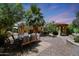 A spacious backyard features a covered dining area, a grill, and mature landscaping, perfect for outdoor entertaining at 30248 W Earll Dr, Buckeye, AZ 85396