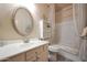 Bright bathroom featuring a large mirror, white cabinets, and a shower-tub combination at 30248 W Earll Dr, Buckeye, AZ 85396