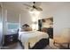 Cozy bedroom with ceiling fan, closet, and a window providing natural light at 30248 W Earll Dr, Buckeye, AZ 85396