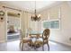 Cozy dining area featuring a glass table with ornate chairs and a sliding door to the backyard at 30248 W Earll Dr, Buckeye, AZ 85396