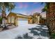 Charming exterior view showcasing the home's desert landscaping and well-maintained two-car garage at 30248 W Earll Dr, Buckeye, AZ 85396