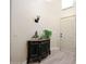 Inviting foyer features a decorative cabinet, wall sconce, and a view of the front door at 30248 W Earll Dr, Buckeye, AZ 85396