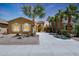 Inviting single-story home with manicured landscaping and a long private driveway, surrounded by palm trees at 30248 W Earll Dr, Buckeye, AZ 85396