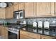Gourmet kitchen with granite countertops, tiled backsplash, and stainless steel appliances at 30248 W Earll Dr, Buckeye, AZ 85396