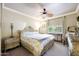Comfortable main bedroom with neutral tones, a ceiling fan, and a window overlooking the backyard at 30248 W Earll Dr, Buckeye, AZ 85396