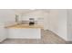 Spacious open kitchen with white cabinets, wood countertops, and stainless steel appliances at 3029 N 83Rd Ln, Phoenix, AZ 85037