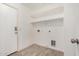 Clean, functional laundry room with shelving and tile flooring at 3029 N 83Rd Ln, Phoenix, AZ 85037