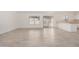 Bright living room featuring sliding glass doors to backyard and wood-look tile flooring at 3029 N 83Rd Ln, Phoenix, AZ 85037