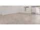 Spacious open living space with neutral walls, recessed lighting, wood-look tile flooring, and natural light at 3029 N 83Rd Ln, Phoenix, AZ 85037