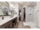 Bathroom boasts double sinks, luxurious shower, and open doorway to walk-in closet at 3437 E Appaloosa Rd, Gilbert, AZ 85296
