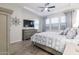 Bright bedroom features wood floors, tray ceiling, television, and neutral gray decor at 3437 E Appaloosa Rd, Gilbert, AZ 85296