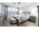 Bright bedroom features wood floors, tray ceiling, windows, and neutral gray decor at 3437 E Appaloosa Rd, Gilbert, AZ 85296