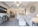 Open-concept living room with a sectional sofa, TV, and views into the kitchen and dining areas at 3437 E Appaloosa Rd, Gilbert, AZ 85296
