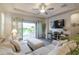 Inviting living room with comfortable seating, ceiling fan, and sliding glass doors to the outdoor area at 3437 E Appaloosa Rd, Gilbert, AZ 85296