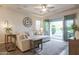 Comfortable living room with neutral tones, stylish decor, and sliding glass doors opening to the backyard at 3437 E Appaloosa Rd, Gilbert, AZ 85296