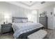 Serene main bedroom with a tray ceiling, elegant furniture, and an attached bathroom at 3437 E Appaloosa Rd, Gilbert, AZ 85296