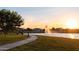 Scenic view of pond with fountain and walking path at sunset at 3437 E Appaloosa Rd, Gilbert, AZ 85296