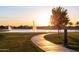 Picturesque walking path at sunset near the community pond and fountains with surrounding landscaping at 3437 E Appaloosa Rd, Gilbert, AZ 85296