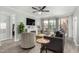 Open living room with a ceiling fan, fireplace, hardwood floors and balcony access at 3600 N Hayden Rd # 3405, Scottsdale, AZ 85251