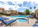 Inviting community pool and spa area surrounded by modern buildings and lush greenery at 3600 N Hayden Rd # 3405, Scottsdale, AZ 85251