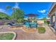 Resort-style backyard with a sparkling pool, outdoor seating, and lush landscaping at 3736 E Cotton Ct, Gilbert, AZ 85234