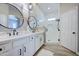 Modern bathroom featuring double sinks, decorative mirrors, and a glass-enclosed shower at 3736 E Cotton Ct, Gilbert, AZ 85234