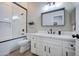 Well-lit bathroom features a vanity with framed mirror and a tiled shower at 3736 E Cotton Ct, Gilbert, AZ 85234