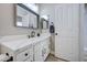 Bathroom featuring a vanity with framed mirror and a shaker style door at 3736 E Cotton Ct, Gilbert, AZ 85234