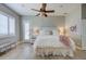 Bright bedroom with wood flooring, ceiling fan, white bed and plantation shutters at 3736 E Cotton Ct, Gilbert, AZ 85234