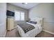 Comfortable bedroom with plush bedding, a white paneled headboard, and a mounted TV at 3736 E Cotton Ct, Gilbert, AZ 85234