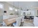 Charming dining area featuring a rustic wooden table and stylish pendant lighting at 3736 E Cotton Ct, Gilbert, AZ 85234