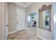 Inviting entryway with tiled floors, a white front door, and an adjacent home office, offering both style and functionality at 3736 E Cotton Ct, Gilbert, AZ 85234