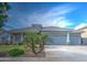 Inviting single-story home featuring a well-manicured lawn and a spacious two-car garage at 3736 E Cotton Ct, Gilbert, AZ 85234