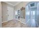 Elegant foyer with wood-look tile flooring, arched doorways, and a view into a bright office space at 3736 E Cotton Ct, Gilbert, AZ 85234