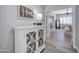 Hallway leading to the main bedroom with white cabinet and 'Home' decor at 3736 E Cotton Ct, Gilbert, AZ 85234