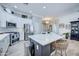 Modern kitchen with quartz countertops, stainless steel appliances, a large island with seating, and ample cabinet space at 3736 E Cotton Ct, Gilbert, AZ 85234