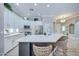 Spacious kitchen with an expansive island, bar seating, and white cabinetry with modern stainless steel appliances at 3736 E Cotton Ct, Gilbert, AZ 85234