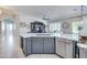 Stylish kitchen island with gray cabinets, stainless steel appliances, and quartz countertops at 3736 E Cotton Ct, Gilbert, AZ 85234