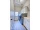 Bright laundry room with modern washer and dryer, ample storage, and a door to the outside at 3736 E Cotton Ct, Gilbert, AZ 85234