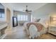 Serene main bedroom featuring plantation shutters, a ceiling fan, and tasteful decor creating a relaxing retreat at 3736 E Cotton Ct, Gilbert, AZ 85234