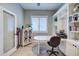 Well-lit home office featuring a modern desk, custom built-ins for storage and organization, and ample natural light at 3736 E Cotton Ct, Gilbert, AZ 85234