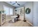 Bright and functional home office with built-in shelving, a modern desk, and a ceiling fan for added comfort at 3736 E Cotton Ct, Gilbert, AZ 85234