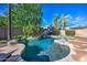 Gorgeous freeform pool with stone accents and lush landscaping, perfect for outdoor relaxation at 3736 E Cotton Ct, Gilbert, AZ 85234