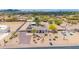 Expansive aerial view of desert property featuring a charming home, guest homes, outbuildings and attractive landscaping at 37508 N 12Th St, Phoenix, AZ 85086